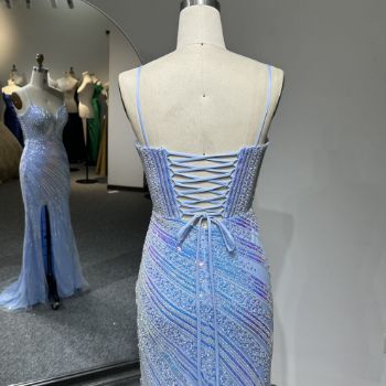 Back view of a dress featuring a low back with delicate crossover ribbon straps secured by a thin waist tie bow.