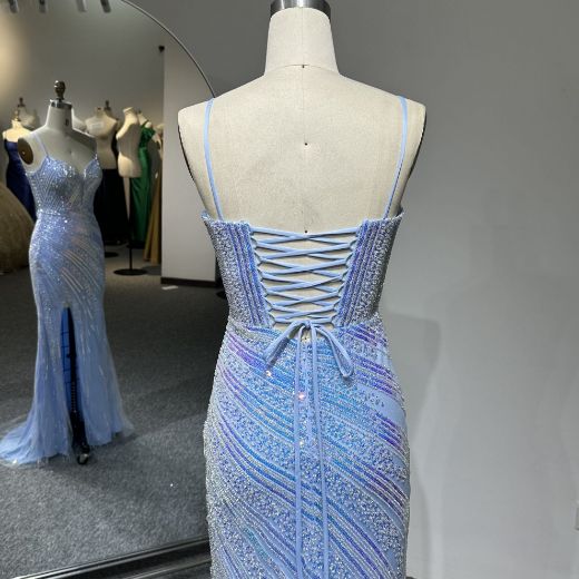 Back view of a dress featuring a low back with delicate crossover ribbon straps secured by a thin waist tie bow.
