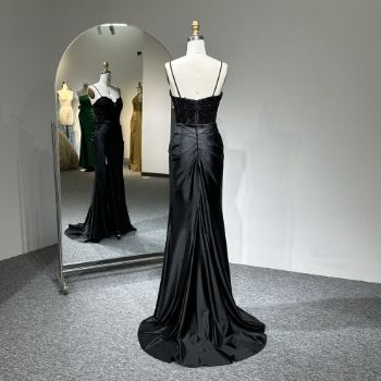 Viewed from the back, it reveals a sensual dipped back with the illusion of a negligee, flowing into an elegant liquid train.