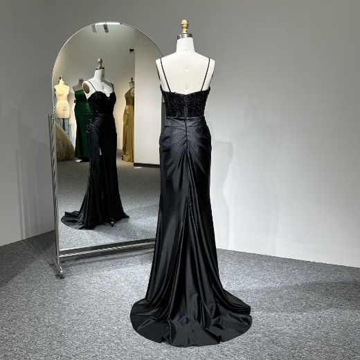 Viewed from the back, it reveals a sensual dipped back with the illusion of a negligee, flowing into an elegant liquid train.