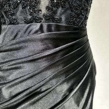Exquisitely clustered cascade pleats from waist to hip at the front