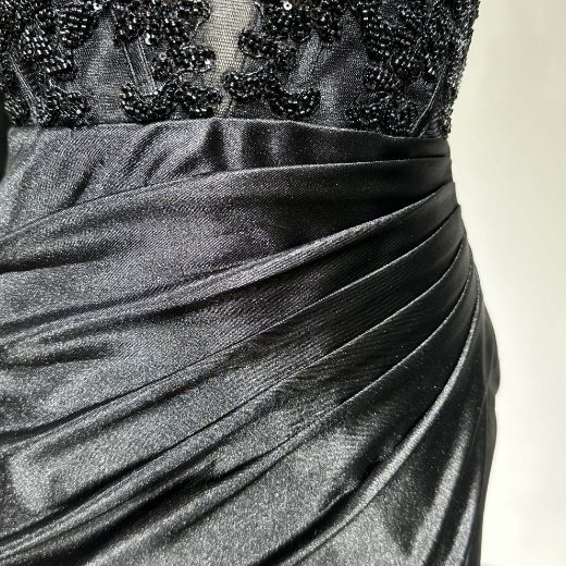 Exquisitely clustered cascade pleats from waist to hip at the front