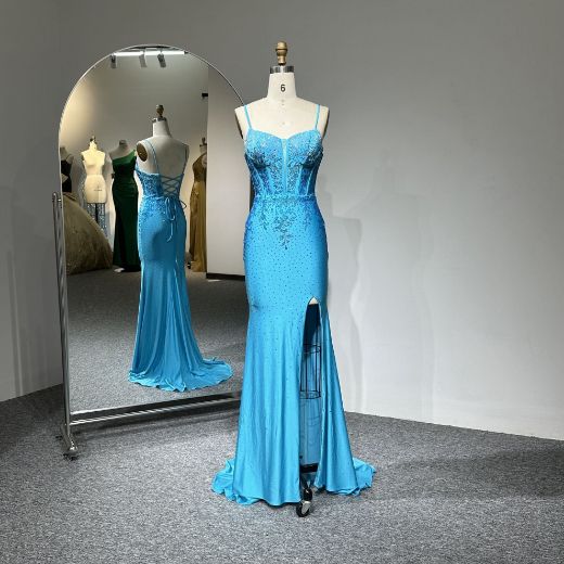 A meticulously designed blue mermaid evening gown that highlights feminine elegance and opulence.